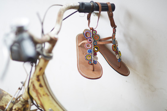 Sandals hanging from a bicycle handle